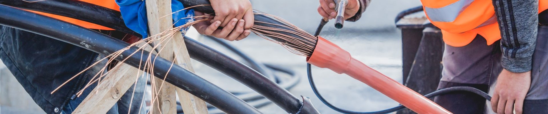 two-electrician-builder-workers-installing-highvoltage-cable